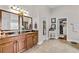 Bathroom features a double vanity with granite counters, tile floors, and a walk-in closet at 1212 Overlook Lake Dr, Dacula, GA 30019