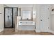 Bright bathroom showcasing a tub, glass shower, and neutral tile at 1212 Overlook Lake Dr, Dacula, GA 30019