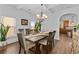 Elegant dining room with hardwood floors, chandelier, and access to the kitchen at 1212 Overlook Lake Dr, Dacula, GA 30019