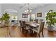 Elegant dining room with hardwood floors and a long, wooden table that seats six at 1212 Overlook Lake Dr, Dacula, GA 30019