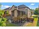 View of a home with a backyard featuring an elevated screened porch and a lower level backyard patio at 1212 Overlook Lake Dr, Dacula, GA 30019