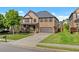 Beautiful exterior of a brick two-story home with a well-kept lawn and a covered porch at 1212 Overlook Lake Dr, Dacula, GA 30019