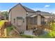 Exterior angle of a home featuring an elevated screened porch and a backyard patio with access to the yard at 1212 Overlook Lake Dr, Dacula, GA 30019