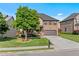 Charming two-story brick home with a well-kept lawn, mature tree, and a welcoming covered front porch at 1212 Overlook Lake Dr, Dacula, GA 30019