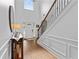 Bright foyer featuring a staircase, hardwood floors, and decorative console table at 1212 Overlook Lake Dr, Dacula, GA 30019