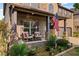 Inviting front porch with rocking chairs, brick columns, and landscaped garden creating an appealing entry at 1212 Overlook Lake Dr, Dacula, GA 30019