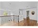 Second floor hallway with hardwood floors and a decorative railing overlooking the foyer at 1212 Overlook Lake Dr, Dacula, GA 30019