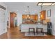 Spacious kitchen with wood cabinets, granite countertops, an island with bar seating and stainless steel appliances at 1212 Overlook Lake Dr, Dacula, GA 30019