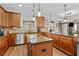 Open kitchen with stainless steel appliances, an island, granite counters and wood cabinets at 1212 Overlook Lake Dr, Dacula, GA 30019