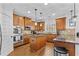 This spacious kitchen offers stainless steel appliances, an island, and granite countertops at 1212 Overlook Lake Dr, Dacula, GA 30019