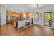 Spacious kitchen with wood cabinets, an island with bar seating, and access to the outdoor patio at 1212 Overlook Lake Dr, Dacula, GA 30019