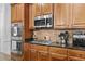 Kitchen with stainless steel microwave, oven, and granite countertops, perfect for cooking at 1212 Overlook Lake Dr, Dacula, GA 30019