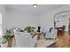 Bright living room featuring hardwood floors, comfortable seating, and adjacent dining area at 1212 Overlook Lake Dr, Dacula, GA 30019