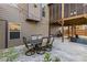 Cozy backyard patio with an outdoor dining table and access to the upper screened porch, perfect for entertaining at 1212 Overlook Lake Dr, Dacula, GA 30019