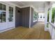 Covered balcony features white railings, wood decking, and charming exterior lighting at 1415 Coretta Bnd, Atlanta, GA 30318