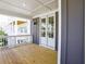 Spacious covered balcony features wood decking, white railings, and exterior wall light at 1415 Coretta Bnd, Atlanta, GA 30318