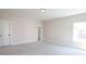 Cozy bedroom with carpeted floors, a window, and a white door at 1415 Coretta Bnd, Atlanta, GA 30318