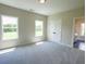 This bedroom features carpet, natural light from two windows, and neutral colored walls at 1415 Coretta Bnd, Atlanta, GA 30318