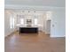 Open concept kitchen with a large island, white cabinets, and modern lighting at 1415 Coretta Bnd, Atlanta, GA 30318