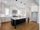 White gourmet kitchen features center island with white countertops and stainless steel appliances at 1415 Coretta Bnd, Atlanta, GA 30318
