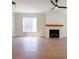 Spacious living room with a fireplace and a ceiling fan above hardwood flooring at 1415 Coretta Bnd, Atlanta, GA 30318