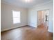 Living room featuring hardwood floors, white trim, and a view into the hall at 1415 Coretta Bnd, Atlanta, GA 30318