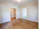 Living room featuring hardwood floors, white trim, and a view of another room at 1415 Coretta Bnd, Atlanta, GA 30318