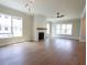 Bright and airy living room featuring a fireplace, hardwood floors, and a modern light fixture at 1415 Coretta Bnd, Atlanta, GA 30318