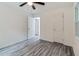 Cozy bedroom with gray wood-look floors, ample natural light, and a ceiling fan at 1482 Connally Sw Ave, Atlanta, GA 30310
