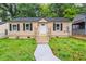 Charming single-story home with tan siding, black shutters, and a well-maintained front yard at 1482 Connally Sw Ave, Atlanta, GA 30310