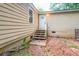 Home exterior featuring a small wooden deck leading to a white back door entrance at 1482 Connally Sw Ave, Atlanta, GA 30310