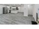 Modern kitchen with white cabinets, stainless steel appliances, an island, and wood plank flooring at 1482 Connally Sw Ave, Atlanta, GA 30310