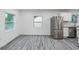 Bright kitchen featuring white cabinets, stainless steel appliances, and wood plank flooring at 1482 Connally Sw Ave, Atlanta, GA 30310