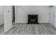 Bright living room with a fireplace, wood plank flooring, and a front door at 1482 Connally Sw Ave, Atlanta, GA 30310