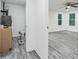 Spacious utility room featuring gray wood-look floors, leading to the bedroom at 1482 Connally Sw Ave, Atlanta, GA 30310