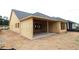 Image shows home under construction; view of the unfinished exterior elevation and covered patio at 251 Strawberry Ln, Woodstock, GA 30189
