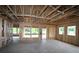 Home under construction showing the interior framing and the layout of rooms with natural light at 251 Strawberry Ln, Woodstock, GA 30189