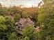 Aerial view of property surrounded by mature trees, with a glimpse of the city skyline in the background at 872 Euclid Ne Ave, Atlanta, GA 30307