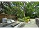 Spacious backyard featuring an outdoor kitchen, fire pit, and mature trees for privacy at 872 Euclid Ne Ave, Atlanta, GA 30307