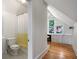 Attic bathroom featuring a toilet and shower plus an adjacent study space at 872 Euclid Ne Ave, Atlanta, GA 30307