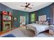 Stylish bedroom with blue walls, a cozy fireplace, and a ceiling fan at 872 Euclid Ne Ave, Atlanta, GA 30307