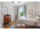 Bright bedroom featuring a bed, vintage dresser, and stylish decor for a comfortable living space at 872 Euclid Ne Ave, Atlanta, GA 30307