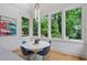 Bright dining room with hardwood floors, modern lighting, and large windows showcasing greenery at 872 Euclid Ne Ave, Atlanta, GA 30307