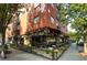 Corner view of a brick building with a restaurant on the ground floor, complete with outdoor patio seating at 872 Euclid Ne Ave, Atlanta, GA 30307
