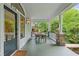 Inviting front porch with dining table, stone pillars, and decorative windows for outdoor entertaining at 872 Euclid Ne Ave, Atlanta, GA 30307