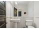 Elegant powder room with a pedestal sink, wainscoting, and decorative mirror at 872 Euclid Ne Ave, Atlanta, GA 30307