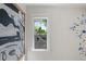 A window showcases a charming view of neighborhood rooftops and trees at 872 Euclid Ne Ave, Atlanta, GA 30307