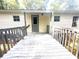 Back porch of home with gray paint and entrance to home through the door at 148 Boogers Hill Rd, Oxford, GA 30054