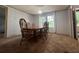 Light-filled dining room with a large wooden table and chairs, providing ample space for entertaining and comfortable dining at 148 Boogers Hill Rd, Oxford, GA 30054