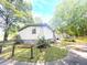 Exterior view of home featuring long driveway, grass yard, and some woods at 148 Boogers Hill Rd, Oxford, GA 30054